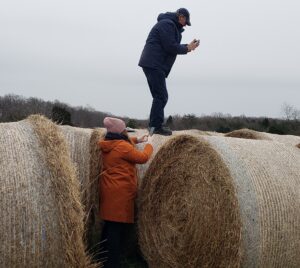 photographer standing on hay bales